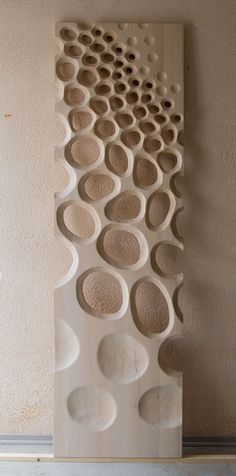 a sculpture made out of wood with circles on it