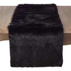 a wooden bench with black fur on it