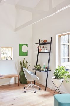 a living room filled with furniture and a ladder in the wall next to a window