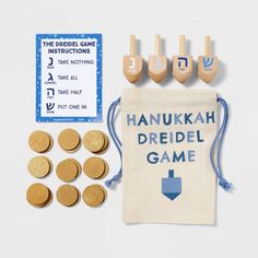 hanukkah dreidel game with wooden pegs and bag