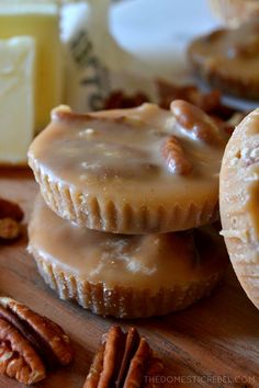 three pecan pies are stacked on top of each other with nuts around them