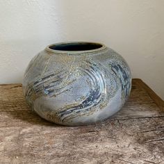 a vase sitting on top of a wooden table