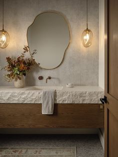 a bathroom with a sink, mirror and light bulbs on the wall next to it