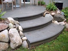 the steps are made out of concrete and have rocks on them