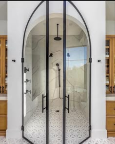 an arched glass shower door in a bathroom