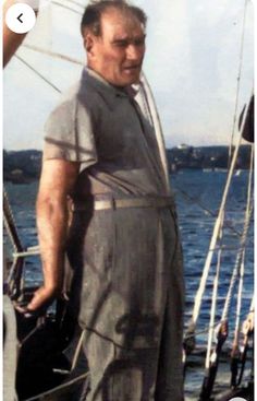 an old man standing on the deck of a boat