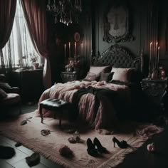 a bedroom with a bed, chandelier and several pairs of shoes on the floor