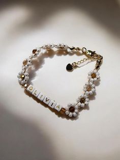 This daisy bracelet is beaded by hand and completely customizable! Personalize it with a name, initials, or meaningful word for a unique gift.  KEY DETAILS: - Handcrafted beaded bracelet with white seed beads and coffee-colored faceted beads - 18K gold plated lobster clasp and chain - Bracelet length of 7 inches with extender for up to 8 inches (if you would like a different size, please contact me) xoxo, Emily Daisy Flower Bracelet, Flower Beaded Bracelet, Beaded Daisy, Daisy Bracelet, Name Initials, Birthday Idea, Bracelet Beaded, Personalized Bracelets, Flower Bracelet