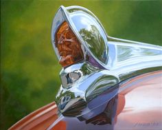 the hood ornament of an old car with a man's face on it