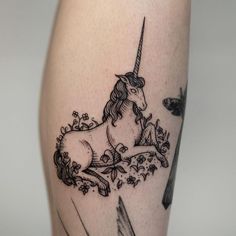 a black and white photo of a unicorn on the leg with an arrow in it