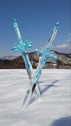 an ice sculpture in the middle of a snow covered field