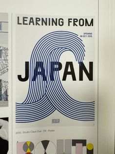 a poster with the words learning from japan written in black and white, on a wall