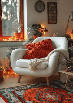 a white chair sitting on top of a rug next to a window