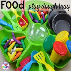 play dough tray with plastic utensils and spoons on it for toddlers to play