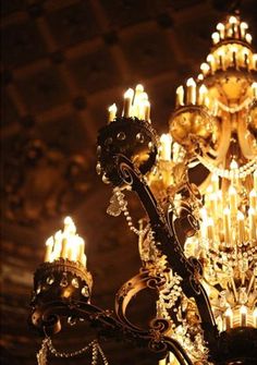 an ornate chandelier with many candles lit