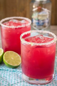 two glasses filled with watermelon margaritas on top of a table