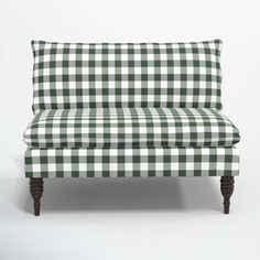 a green and white checkered couch with wooden legs