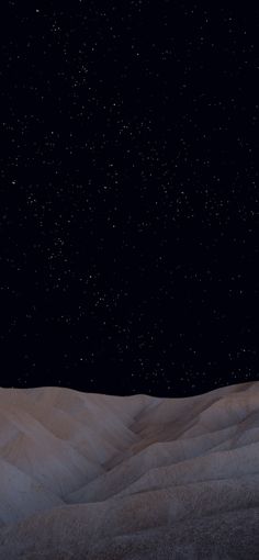 the night sky is filled with stars above sand dunes and hills in the foreground