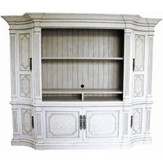 a white entertainment center with wooden paneling and carvings on the doors, drawers and shelves