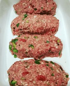 three hamburger patties sitting on top of a white plate