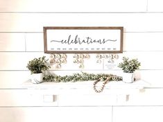 a family birthday and celebration sign on a mantle with potted plants in front of it