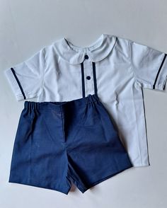 Beautiful toddler outfit, custom made by hand for a littler boy. It will be made with white and navy blue cotton fabrics. Top has blue trims at front and on its sleeves to enhance the set. Made with nice quality 100% cotton fabrics Very comfortable, set includes Shirt and Short. Cotton School Uniform Sets, White School Uniform Sets, Classic Blue Short Sleeve Set, Navy Cotton Playtime Sets, Cotton Navy Sets For Playtime, Baby Boy T Shirt, Outfit Elegant, Baptism Outfit, Cake Smash Outfit