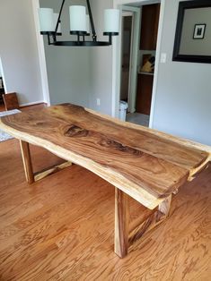 a wooden table sitting on top of a hard wood floor