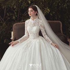 a woman in a white wedding dress sitting on a couch with her hand on her hip