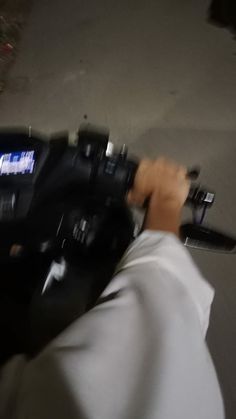 a blurry image of a person holding a camera