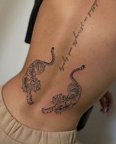 a woman's lower back with two tigers and the words, i love you