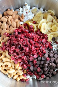 a bowl filled with nuts, cranberries, and other foodstuffs in it