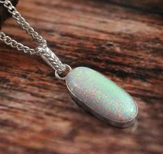 "💎 Gemstone:- Opal, Pendant   💎 Base Material: 925 Sterling Silver  💎 Stamps / Markings: JG (our brand name) 925 (sterling sterling) 💎 Stone Size 25x11 MM  100% SATISFACTION GUARANTEED GIFTING:- - We gladly ship packages directly to the gift recipient - If you mark an order as a Gift, receipts are not included OUR PROMISE:- - High Quality Material - Fine Craftsmanship - Superior Customer Service - Seamless Buying Experience Shipping policy:- Our delivery time is 11-21 days after shipping the Necklace Minimalist, October Birthstone, Oval Pendant, Gift Packs, Opal Pendants, Opal Necklace, Minimalist Necklace, October Birth Stone, Jewelry Pouch