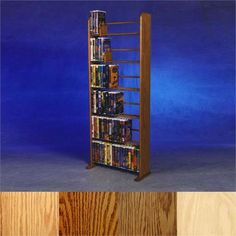 a tall wooden book shelf with several dvd's on top and bottom shelves below