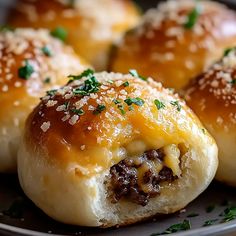 cheeseburger rolls on a plate with parsley sprinkled on top, ready to be eaten