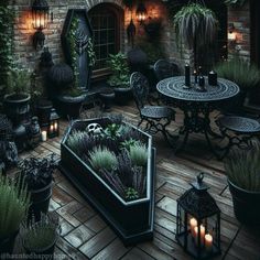 an outdoor patio with potted plants and candles on the table, surrounded by lanterns