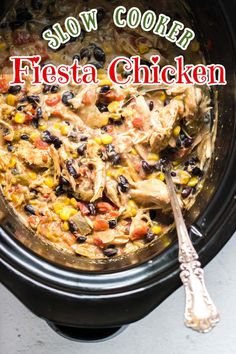 slow cooker fiesta chicken in a crock pot with the words slow cooker fiesta chicken