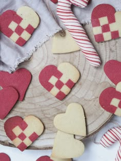 several heart shaped cookies on a plate with candy canes and peppermint sticks