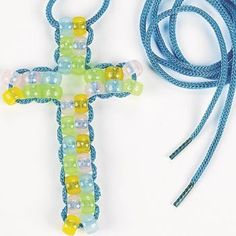 a cross made out of glass beads and string