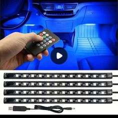 four remote controls in front of a car's interior with blue lighting and an image of