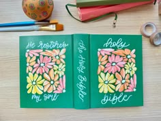 two notebooks with the words happy birthday written on them next to some crafting supplies