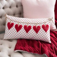 a red and white pillow with hearts on it