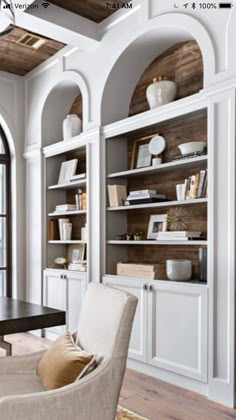 a living room filled with furniture and bookshelves