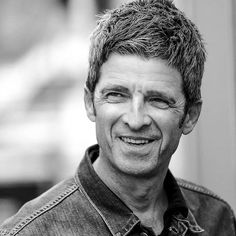 a black and white photo of a man smiling