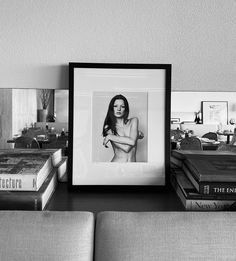 a black and white photo sitting on top of a table next to books