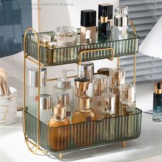 two tiered glass shelf with bottles and cosmetics on it