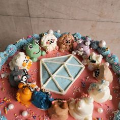 there is a cake decorated with animals and other things on the top of this plate