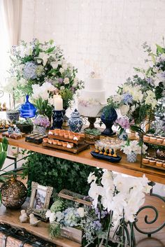 a table topped with lots of desserts and flowers