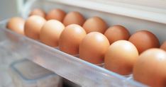 an egg tray filled with lots of brown eggs