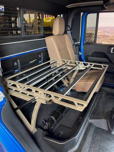 the back end of a blue truck with its bed in it's cargo area