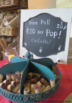 a basket filled with lots of wine corks next to a sign that says wine pull $ 20 per pop